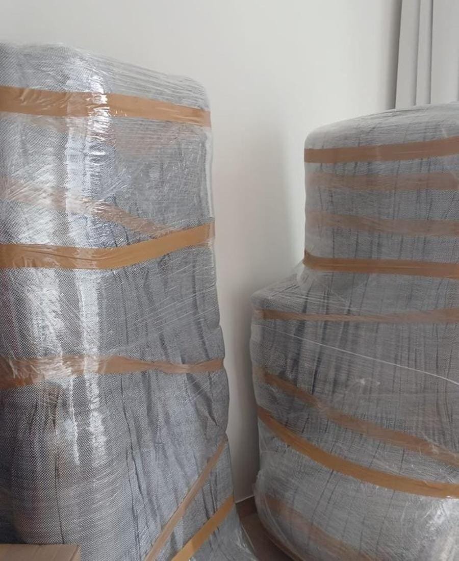 Two large furniture pieces wrapped and taped ready for moving